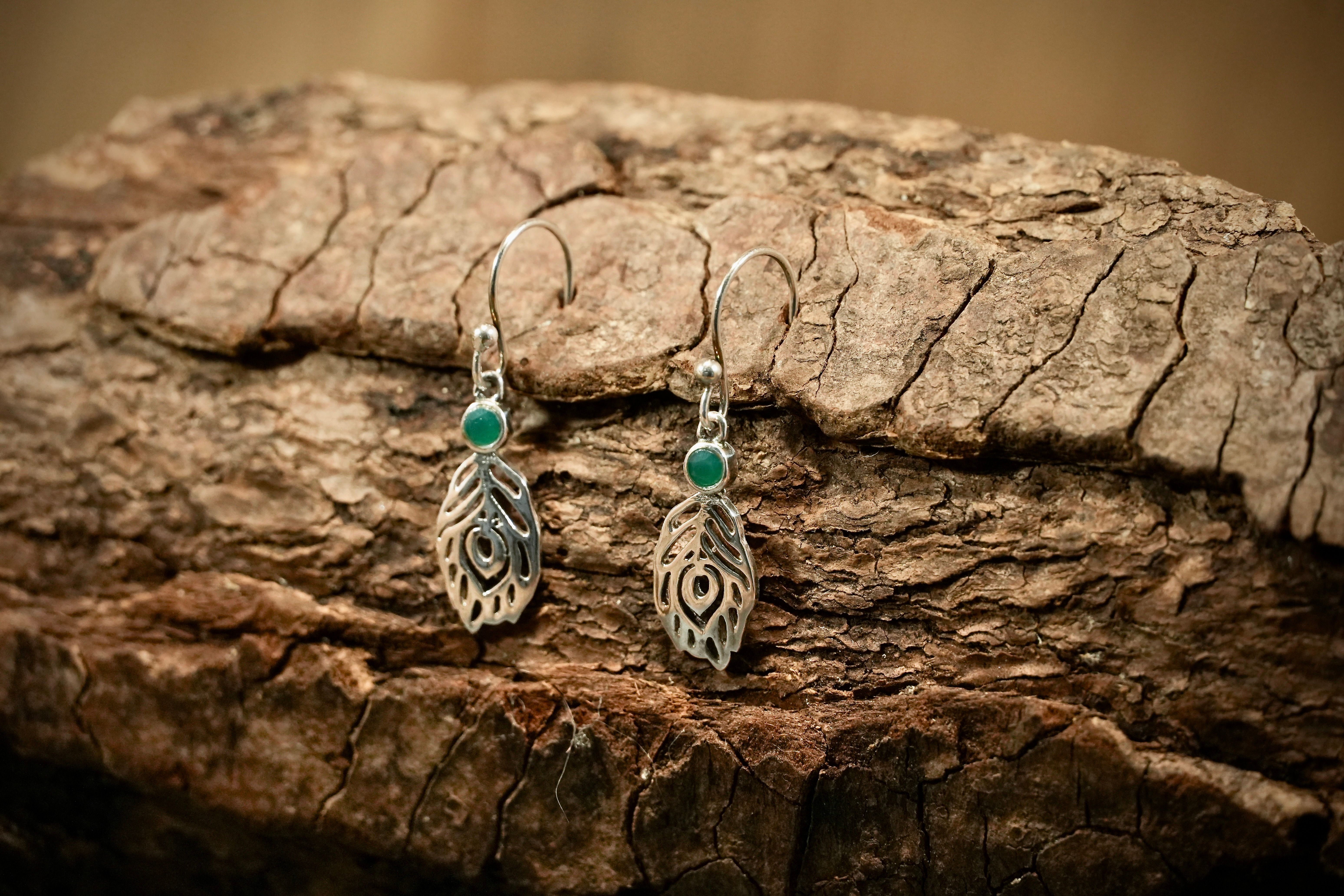 Feather drop earrings with emerald
