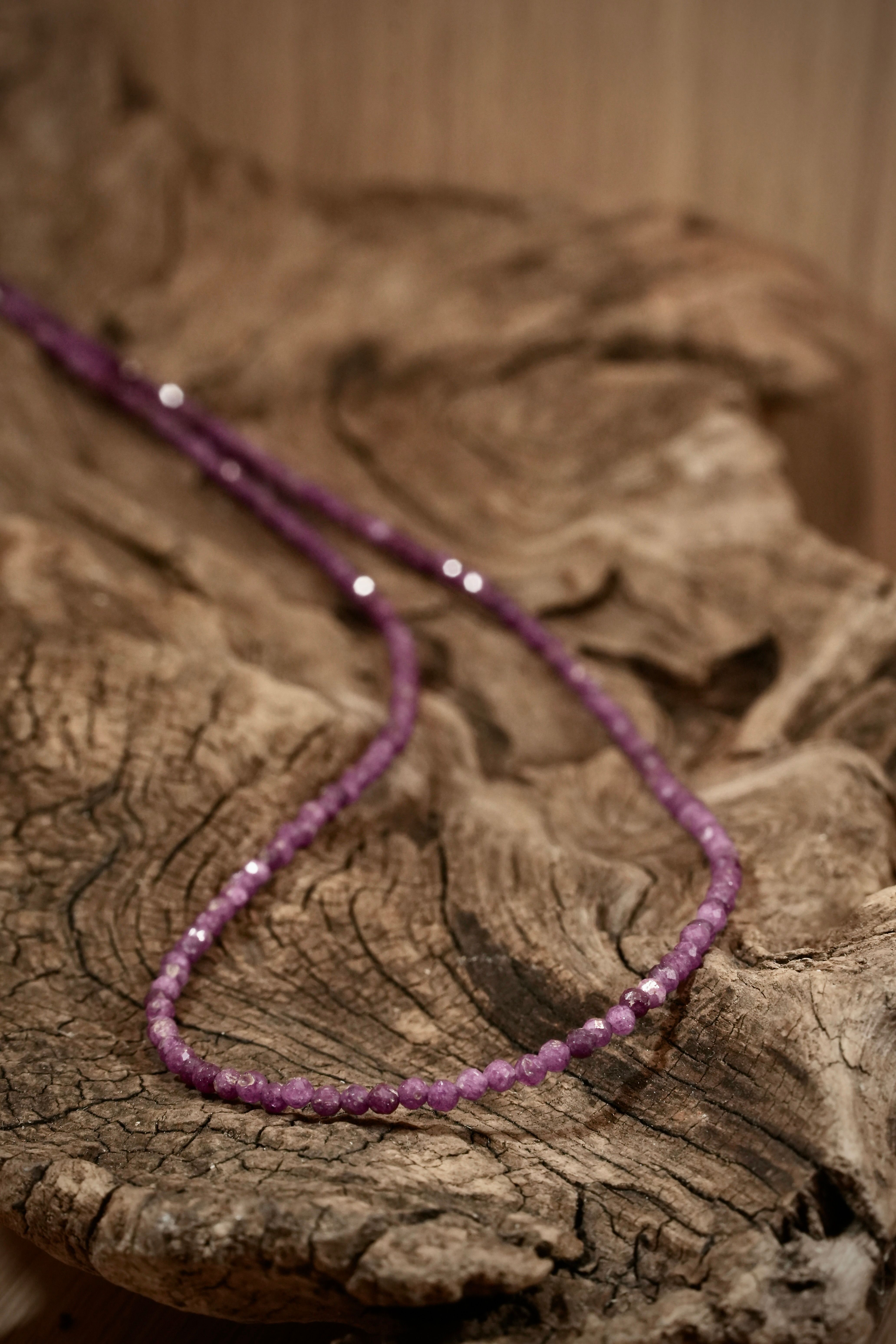 Ruby Pearls necklace on root wood